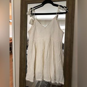 Free People ivory mini dress. 100% cotton. Tassel tie shoulder